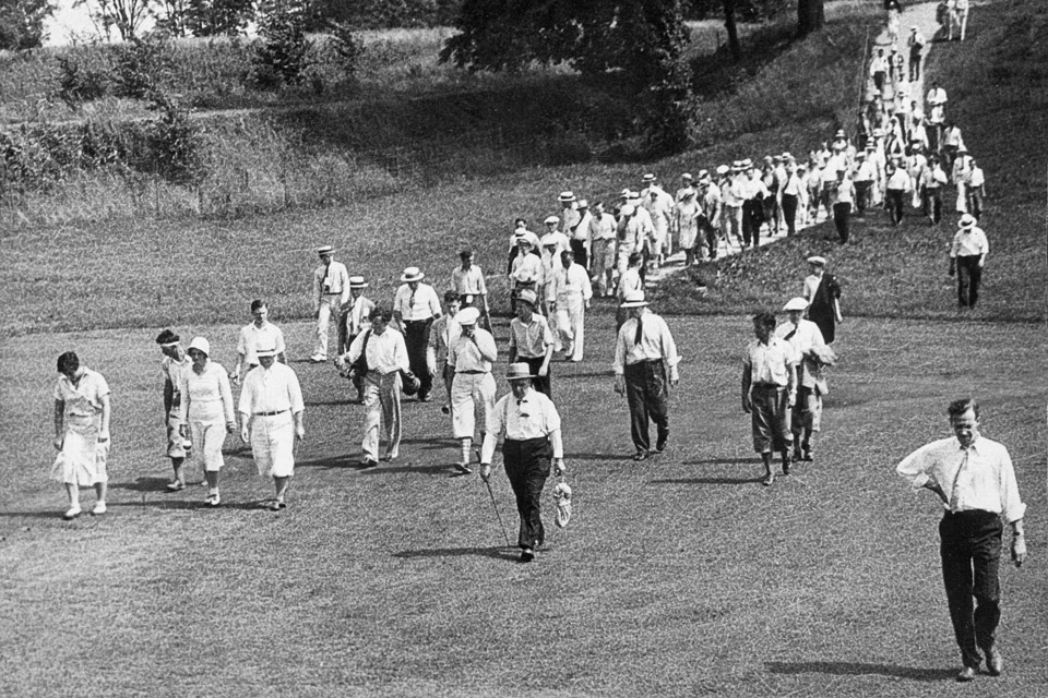 Spectators walking along the fairway