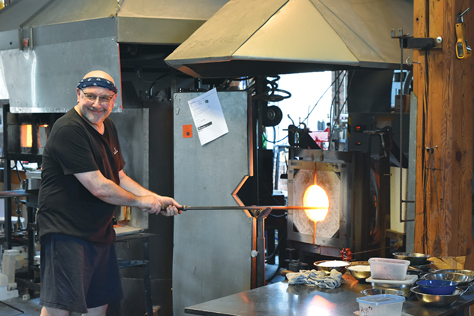 Man at the kiln at The Works (photo by Rachael Jirousek)