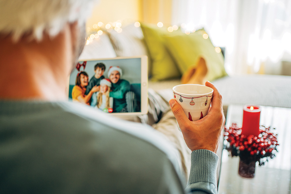 Man looking at family holiday photo (photo by iStock)