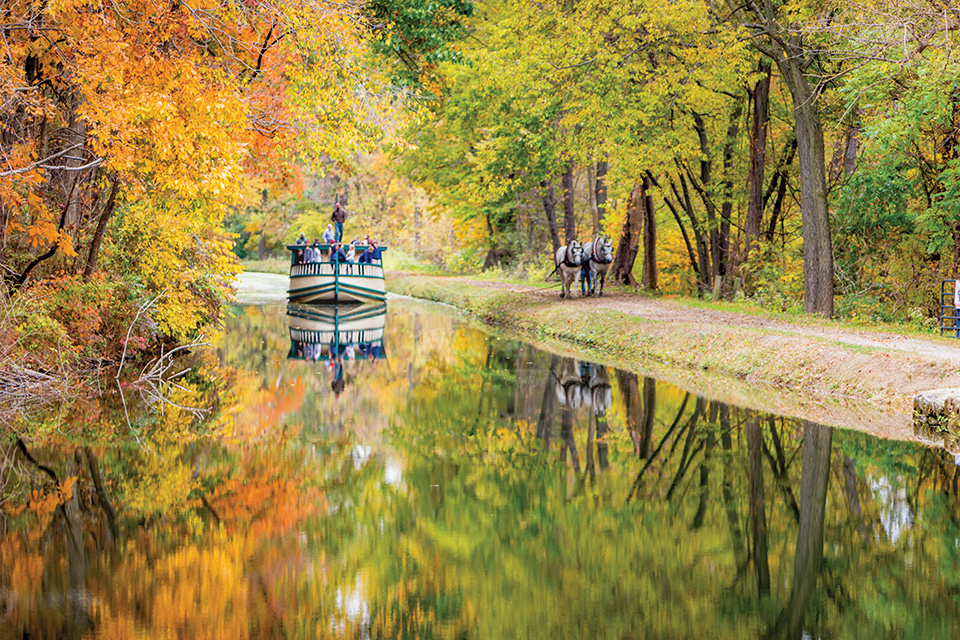 Historic Roscoe Village boat on the water in fall (courtesy of Visit Coshocton)