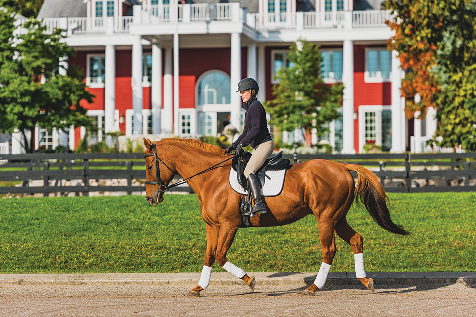 Woman riding horse at Black Star Farms (photo by Tony Demin)