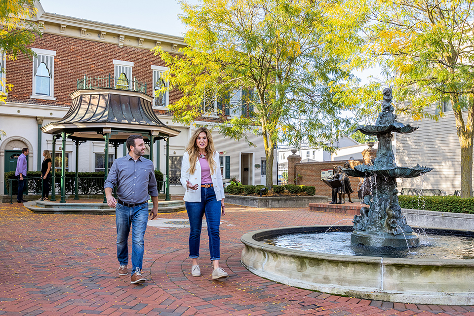 Man and woman walking in downtown Versailles by fountain (photo by Matthew Allen)