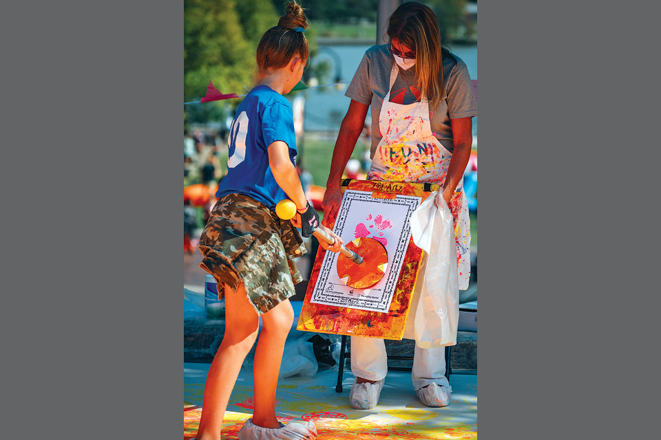 Girl painting at Toledo’s Momentum festival (photo courtesy of The Arts Commission)