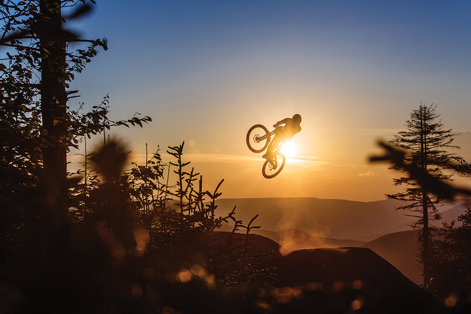 Mountain biker riding at sunset at Snowshoe Mountain Resort in Snowshoe (photo courtesy of West Virginia Department of Tourism)