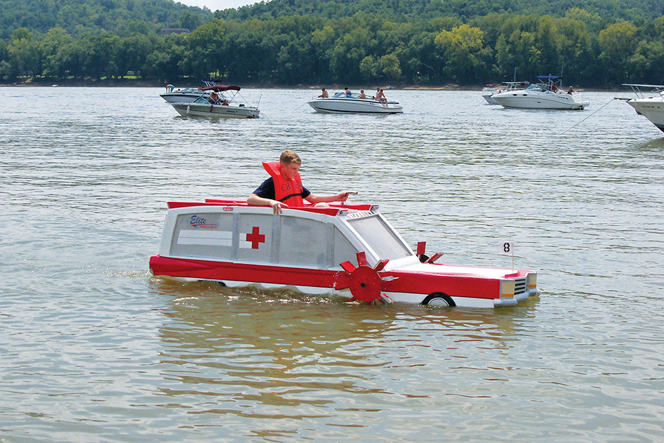 Boy taking part in the cardboard boat regatta at New Richmond’s River Days (photo by Flicker / Scott Amus)