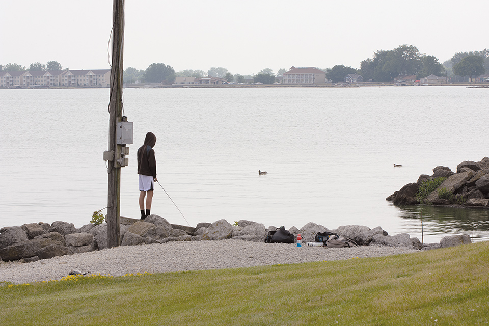 Person fishing along Grand Lake St. Marys in Celina (photo by Rachael Jirousek)