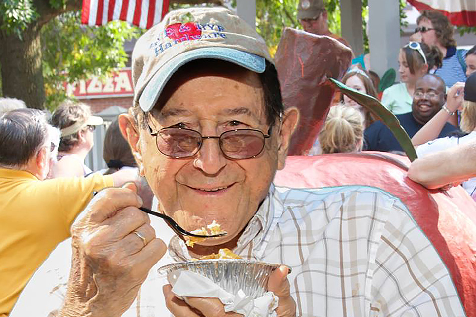 Man enjoying apple dumplings at Johnny Appleseed Festival (courtesy Lisbon Area Chamber of Commerce)