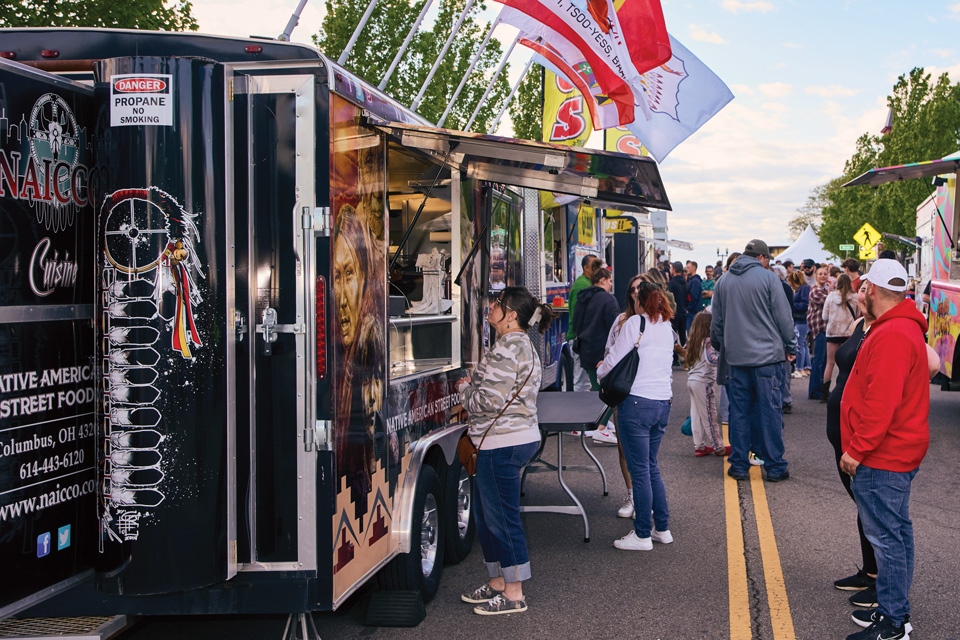 Woman ordering food from NAICCO Cuisine food truck (photo by Brian Kaiser)