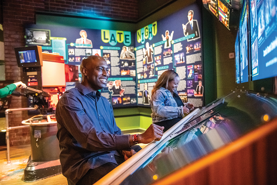 Man at late-night control booth at the National Comedy Center in Jamestown, New York (photo courtesy of National Comedy Center)