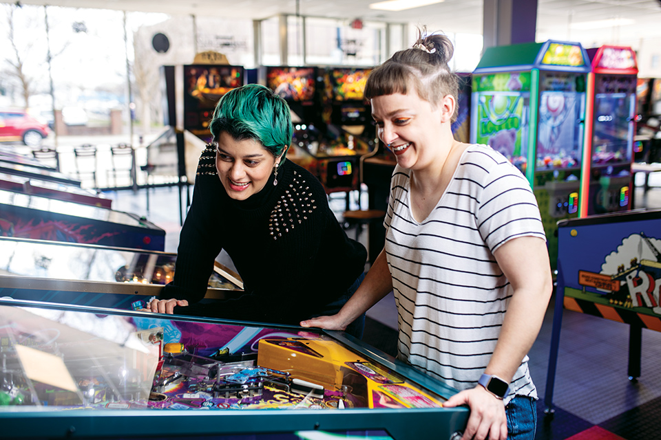 Women playing pinball at Pinball Garage in Hamilton (photo courtesy of Travel Butler County)