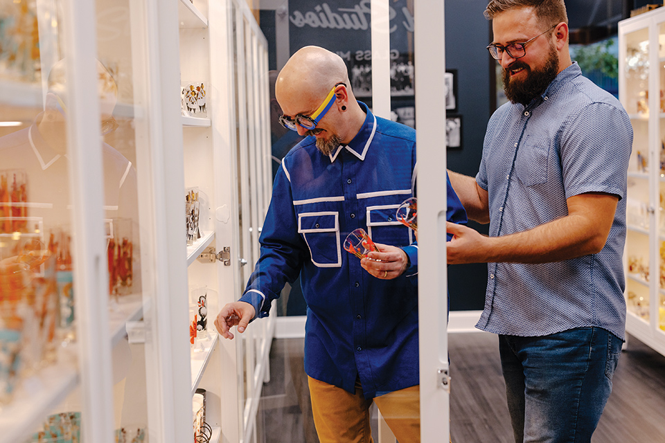 Jason and David Annecy looking at glassware in Gay Fad Studios’ small on-site museum in Lancaster (photo by Megan Leigh Barnard)