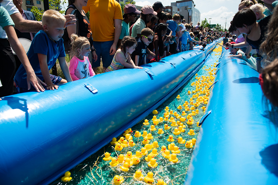 Kids watching Columbus Duck Race at Riverside Crossing Park (photo courtesy of Nationwide Children’s Hospital)