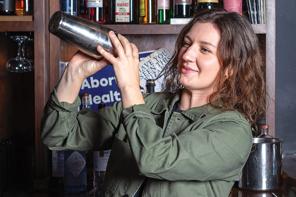 Haley Rataiczak mixing a drink behind the bar at Cloak and Dagger (photo by Josh Dobay Productions)