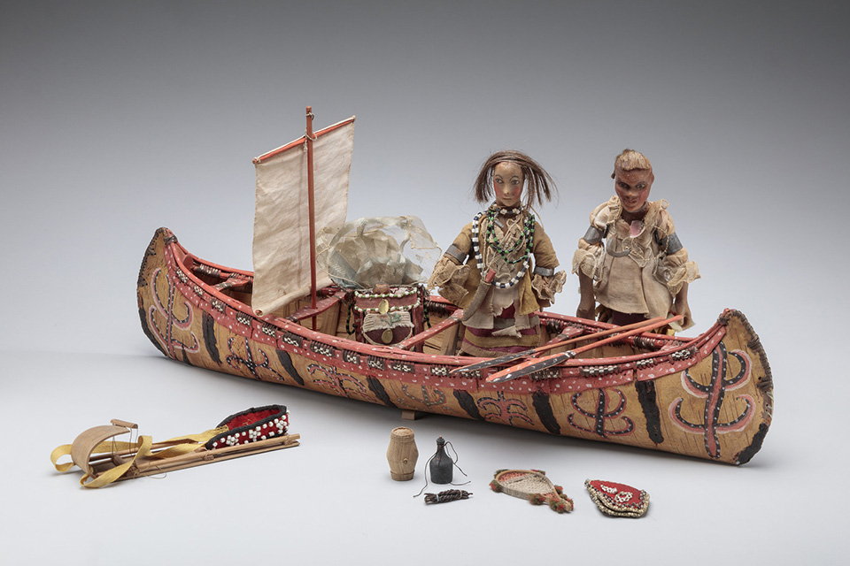 Ancestral Great Lakes Artists, Birchbark Model Canoe and Three Dolls with Assorted Equipment. Mid-18th century. Toledo Museum of Art, purchased with funds from the Libbey Endowment, Gifts of Edward Drummond Libbey, by exchange, 2023.