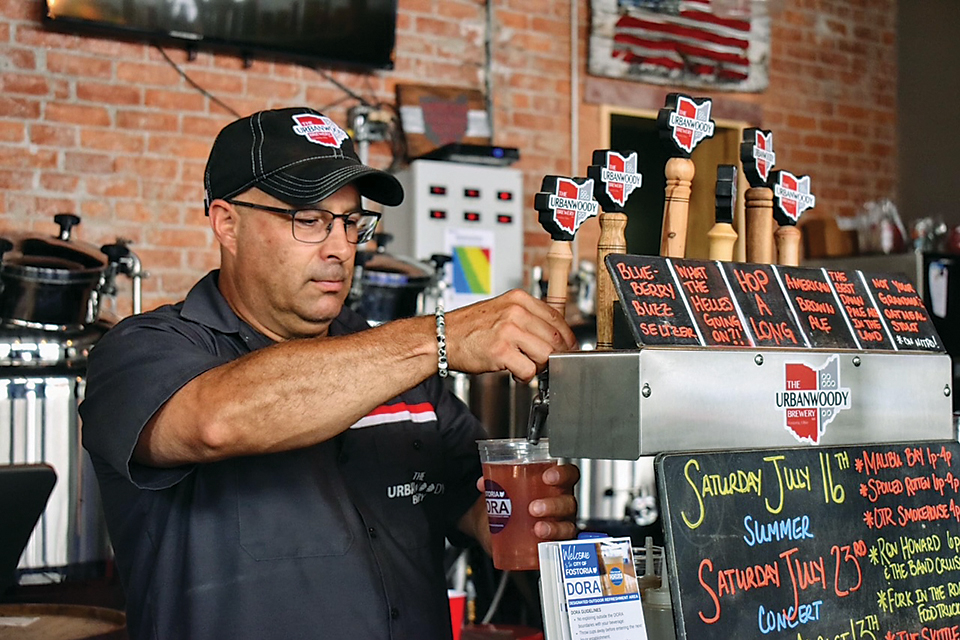The bartender pours a pint at The UrbanWoody Brewery in Fostoria (photo courtesy of The UrbanWoody Brewery)