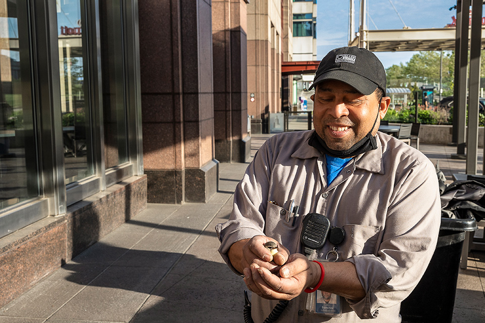 Key Tower security guard Julio Sanchez with a saved bird in Cleveland (photo by Matt Shiffler)