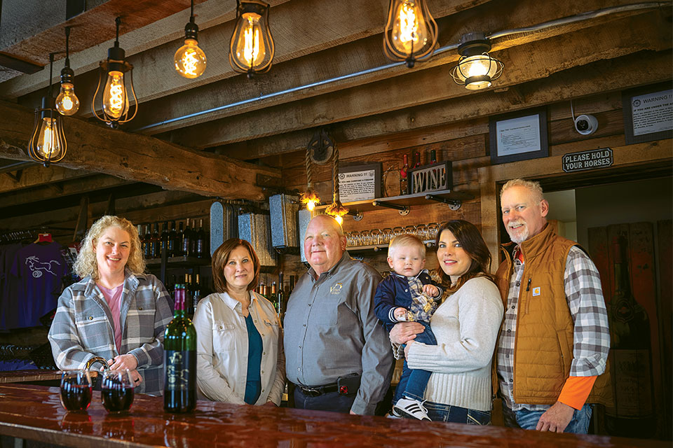 The Krieg family poses for a group photo at their winery's bar. 
