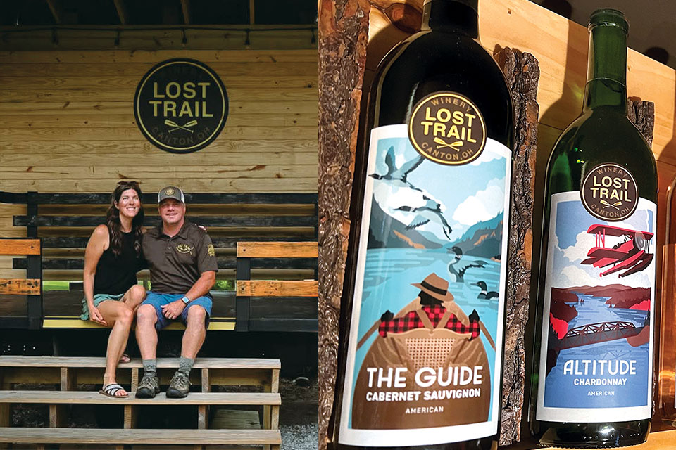A couple pose on the steps of their winery. Two of their wine bottles get the close up. 