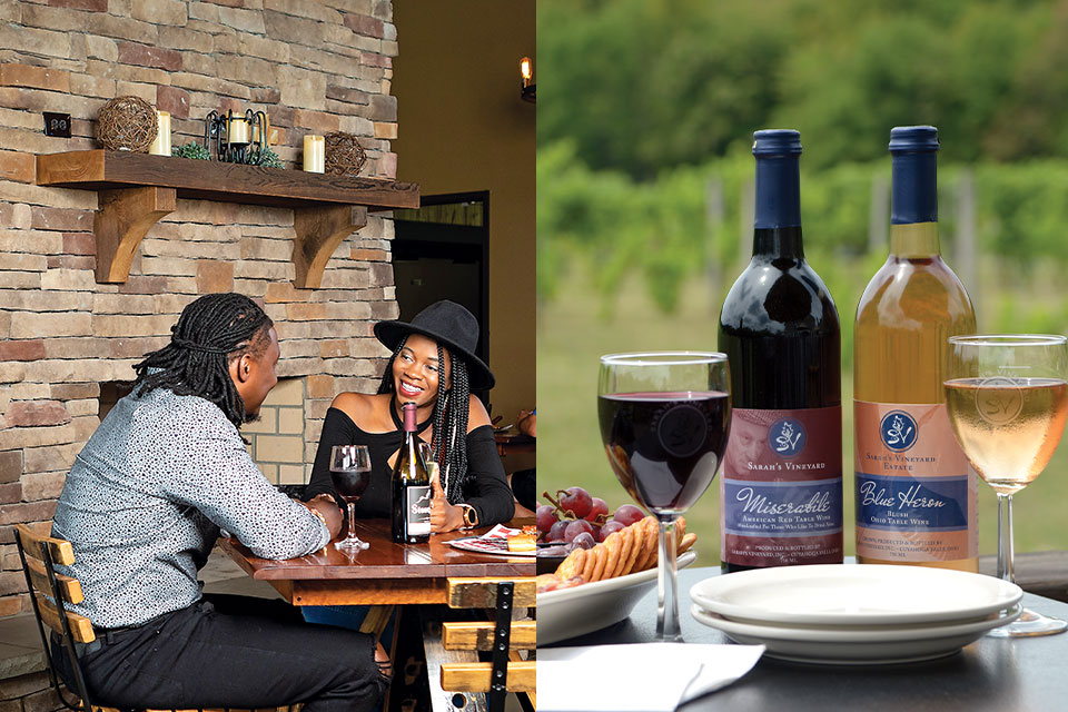 A couple celebrates date night at a rustic winery. Two wine bottles foreground an outdoor vineyard scene.