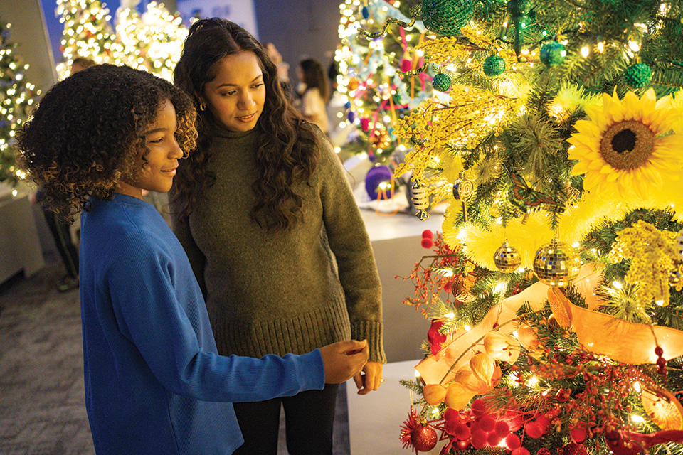People at COSI in Columbus looking at Christmas tree (photo courtesy of COSI)