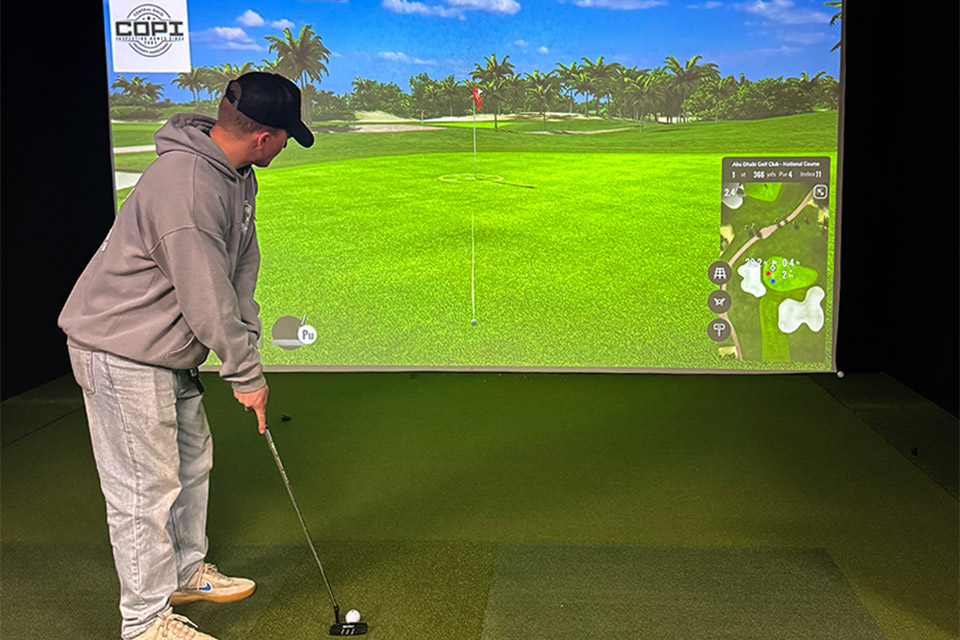 Man putting in front of golf simulator at Bogey’s Indoor Golf in Grove City (photo courtesy of Bogey’s Indoor Golf)