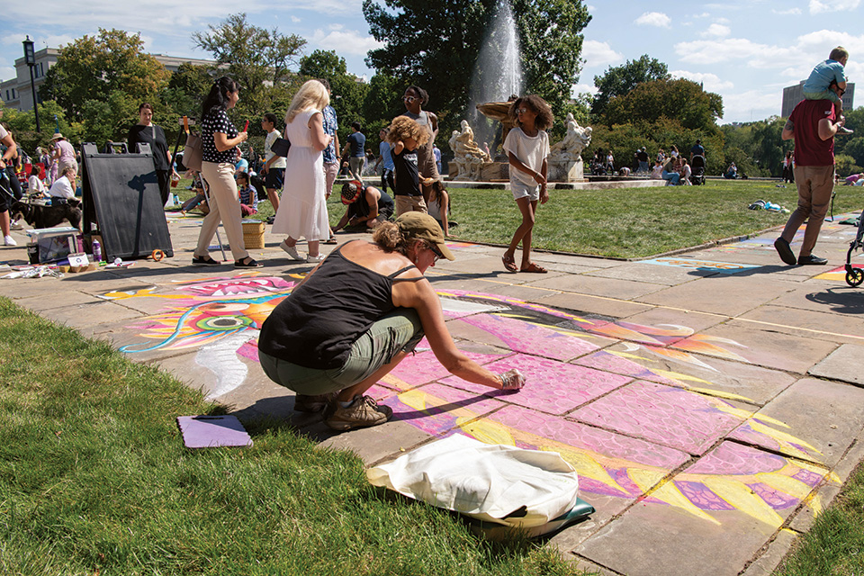 Woman drawing at Chalk Festival at Wade Lagoon outside Cleveland Museum of Art (photo by Greg Nold, courtesy of the Cleveland Museum of Art)