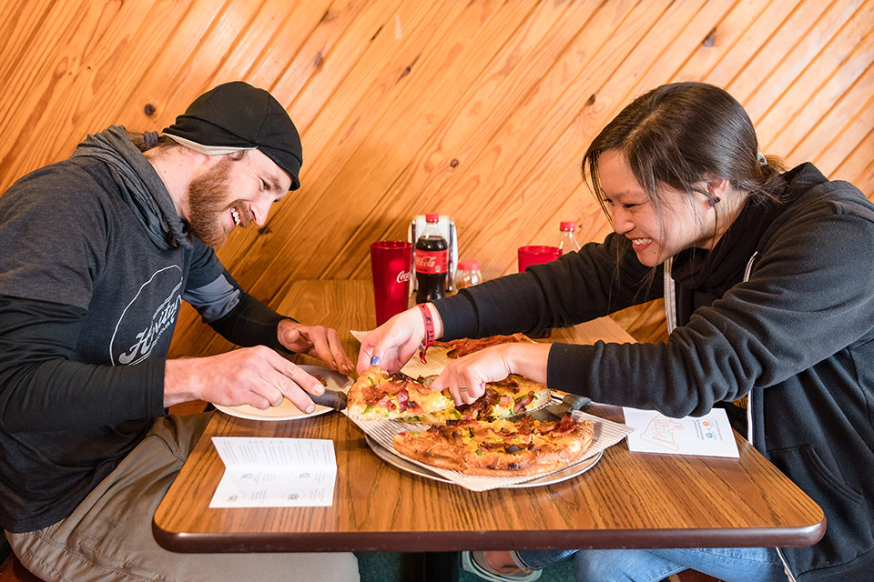 People eating pizza at Grove City’s Pizza Trek (photo courtesy of Visit Grove City)