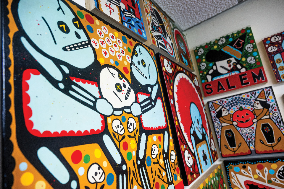 Wall lined with Youngstown artist Mike Egan’s artwork (photo by Ken Blaze)