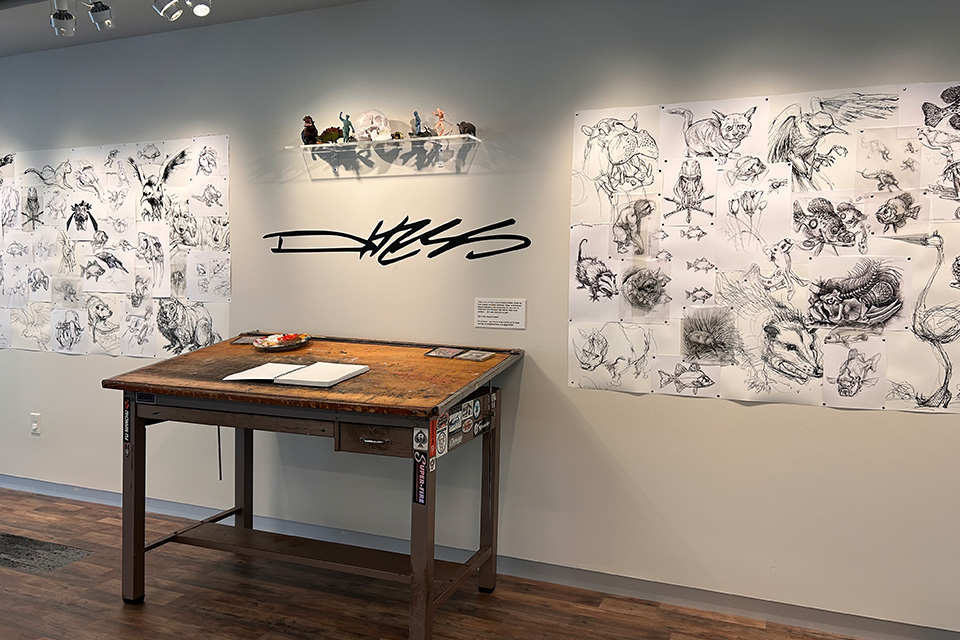 One of artist Derek Hess’ drawing tables is part of the exhibition (photo by Angelo Merendino)
