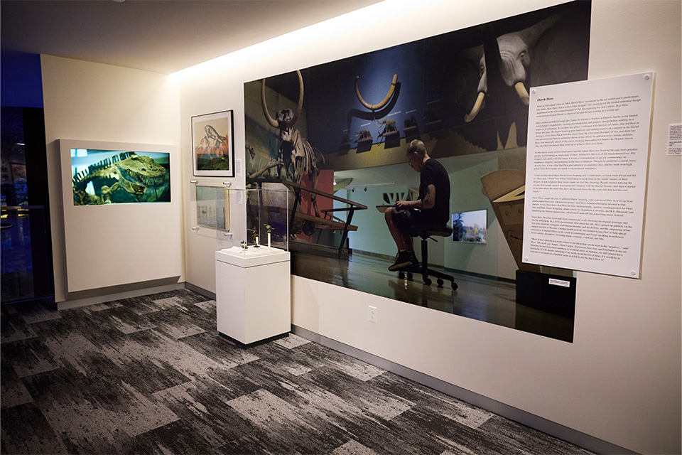 Large photograph of artist Derek Hess drawing at the Cleveland Museum of Natural History (photo by Angelo Merendino)
