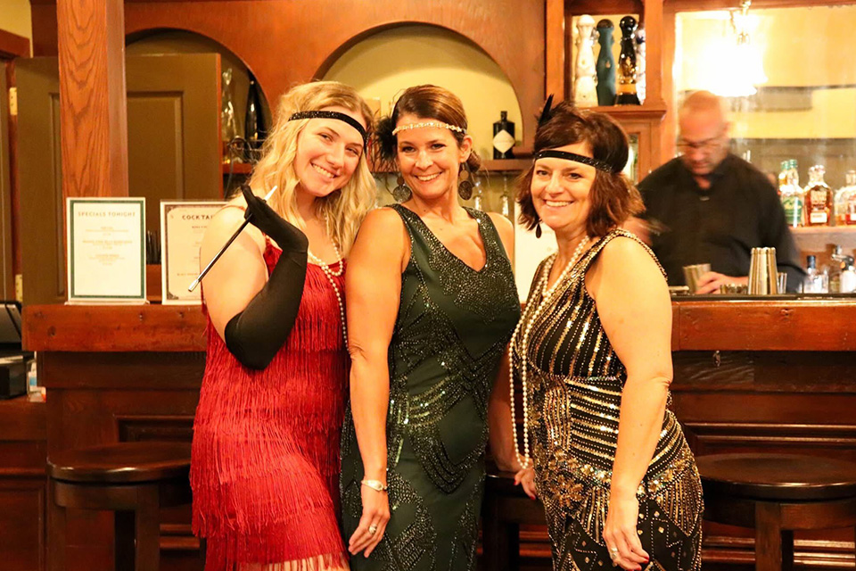 Women dressed in 1920s attire at Sauder Village’s speakeasy (photo courtesy of Sauder Village)