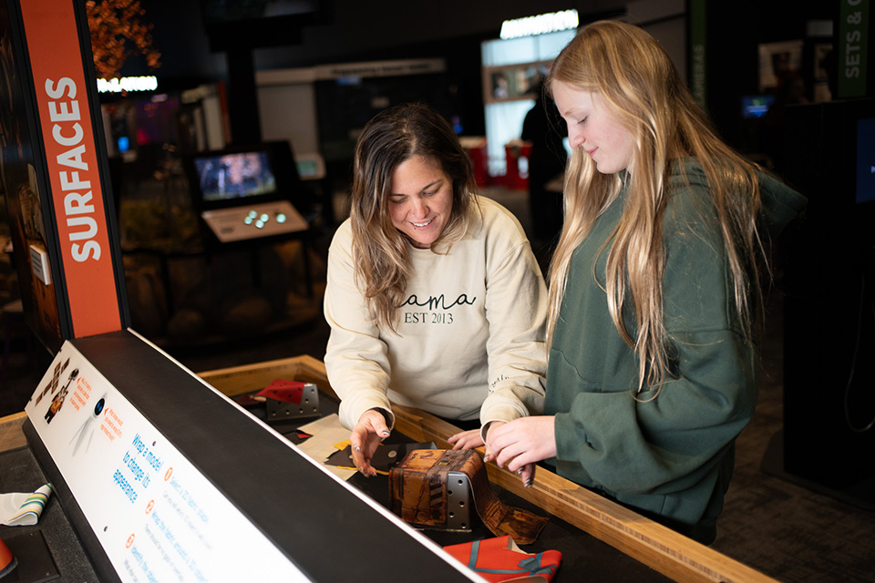 Two girls exploring “The Science of Pixar” at COSI (photo courtesy of COSI)