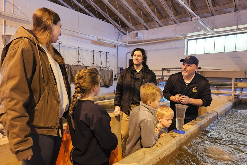 Family talking to Division of Wildlife staff member at Senecaville Fish Hatchery (photo courtesy of Ohio Department of Natural Resources)