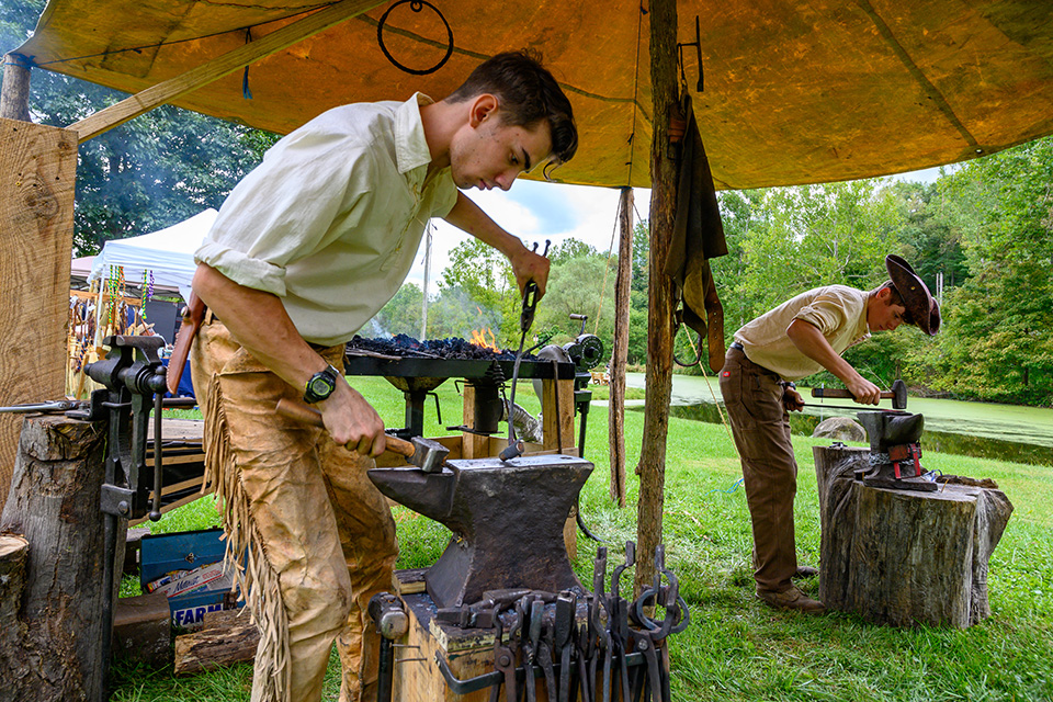People blacksmithing at Ohio Heritage Days in Lucas’ Malabar Farm State Park (photo courtesy of Destination Mansfield)