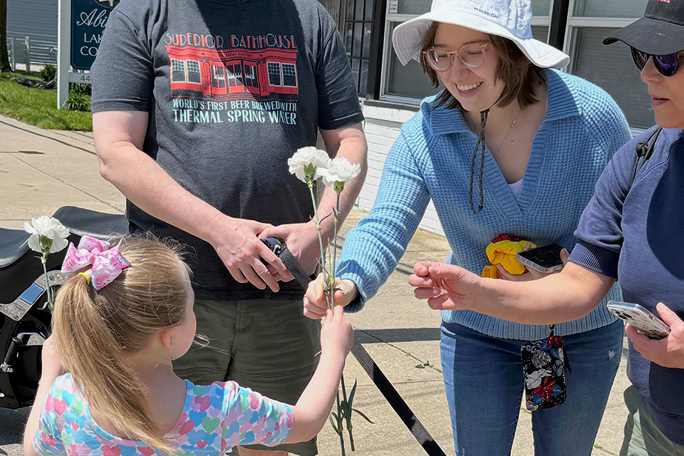 Girl holding flowers during Mother's Day event at Geneva-on-the-Lake (photo courtesy of Ashtabula County Visitors Bureau)