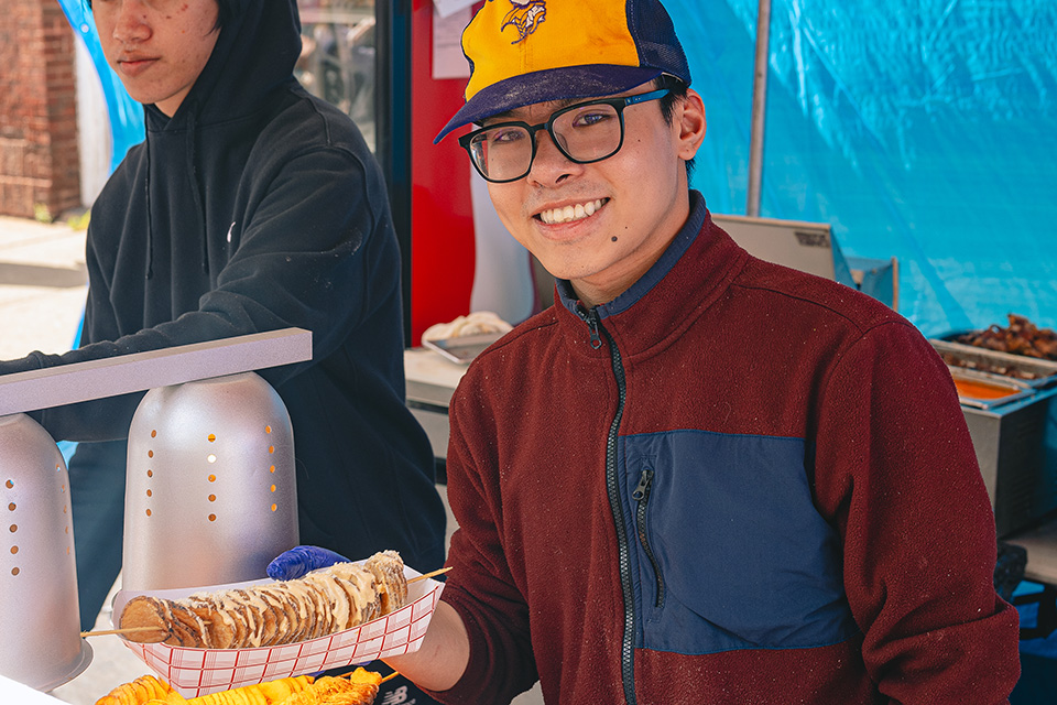 Man serving food at Cincinnati’s Asian Food Festival (photo by Frank D. Young)