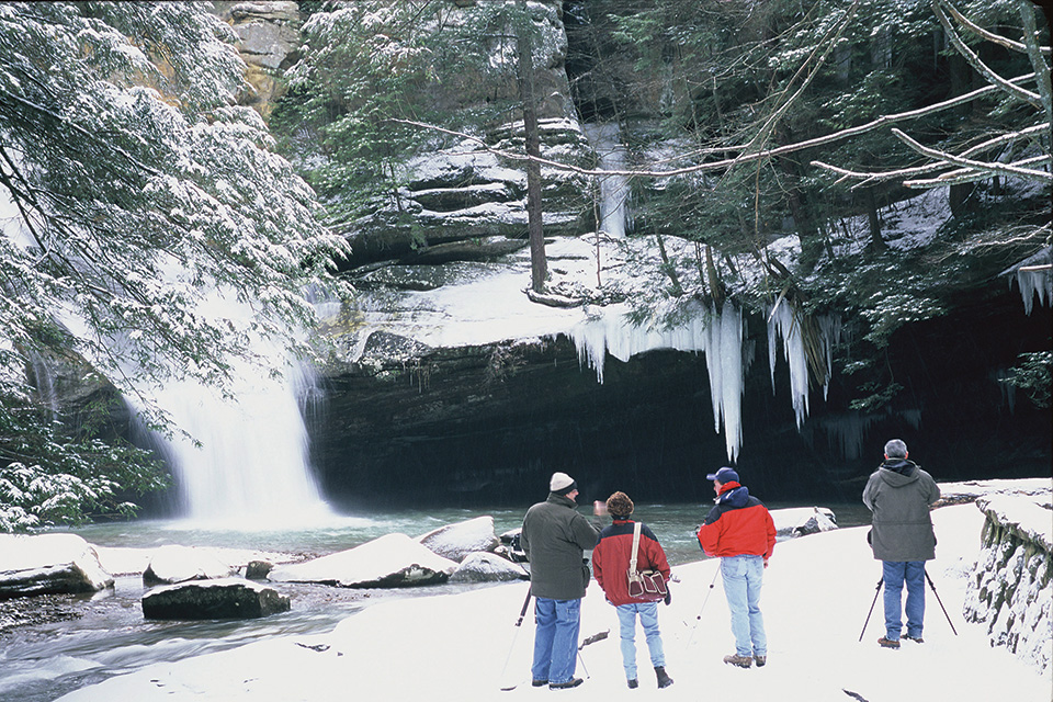 People hiking at Hocking Hills State Park’s Cedar Falls in winter (photo courtesy of Hocking Hills State Park) People hiking at Hocking Hills State Park’s Cedar Falls in winter (photo courtesy of Hocking Hills State Park)