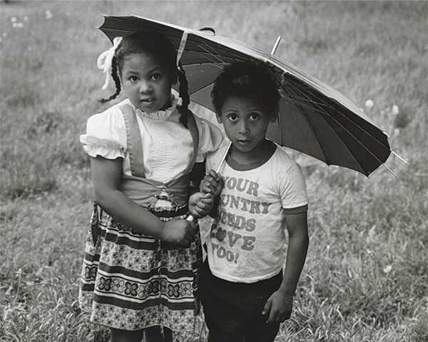 Kids with umbrella in Yellow Springs field (photo by Donna Silvert)