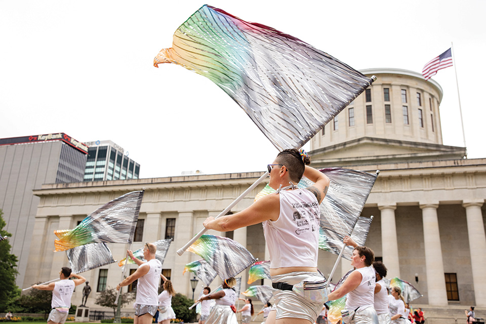 People waving pride flags at Columbus Pride downtown (photo courtesy of Stonewall Columbus and Emma Parker Photography)