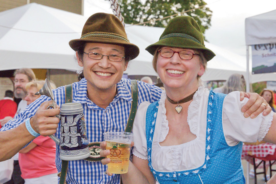 People in traditional German garb with beer at the Germanfest Picnic in Dayton (photo by Adam Alonzo)