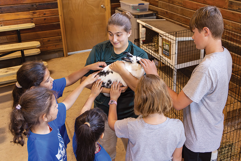 Kids petting rabbit at Lake Metroparks Farmpark in Kirtland (photo by Al Susinskas)