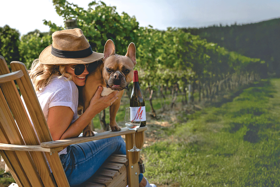 Woman with French bulldog at Buccia Vineyard Winery and B&B in Conneaut (photo by Brandi Papania)