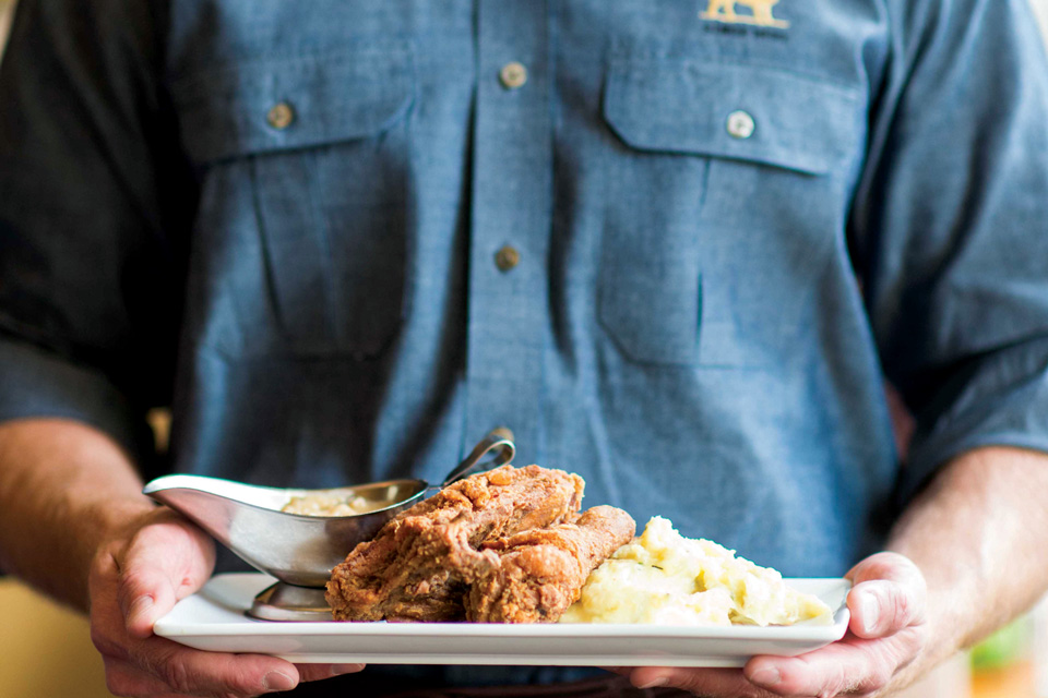 Person holding plate of food from the Golden Lamb in Lebanon (photo by Ryan Kurtz)