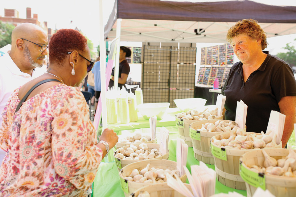 People at stand at Cleveland Garlic Festival (photo by K. Bitto Photography)