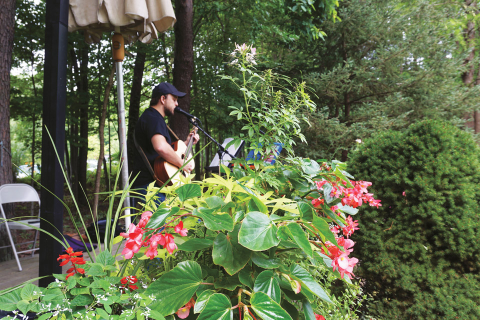 Man performing at Lilyfest at Bishop Educational Gardens in Rockbridge (photo courtesy of Lilyfest)