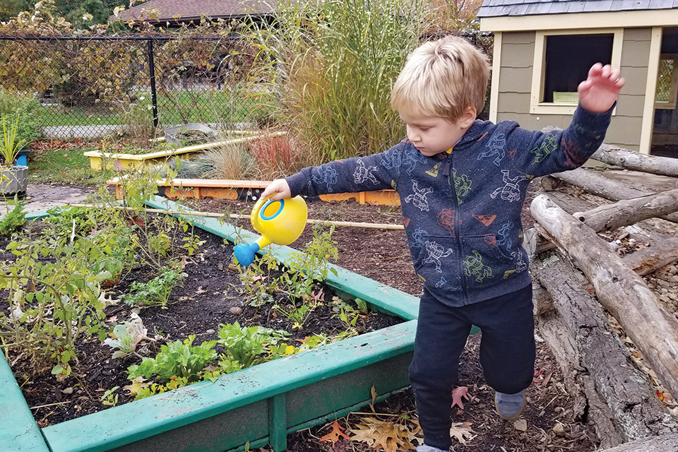 Boy watering garden at Penitentiary Glen Reservation’s Nature Play in Kirtland (photo courtesy of Lake Metroparks)