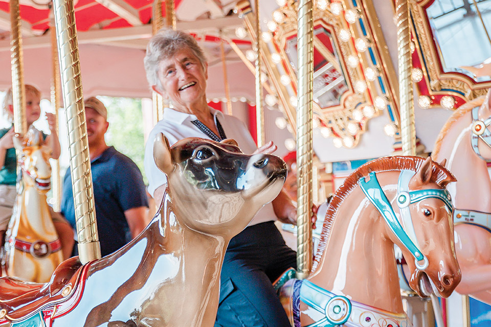 Woman on carousel at Cowtherine’s Carousel Round and Round Celebration Week at Young’s Jersey Dairy in Yellow Springs (photo courtesy of Young’s Jersey Dairy)
