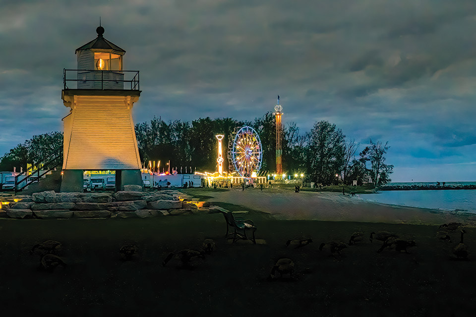 Port Clinton Lighthouse at dusk during Port Clinton Walleye Festival (photo courtesy of Shores & Islands Ohio)