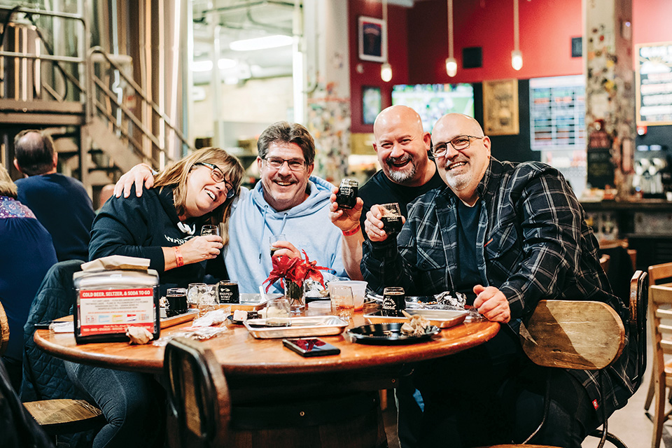 Patrons enjoy beers in the taproom at Warped Wing Brewing Co. in Dayton, Ohio (photo courtesy of Warped Wing Brewing Co.)