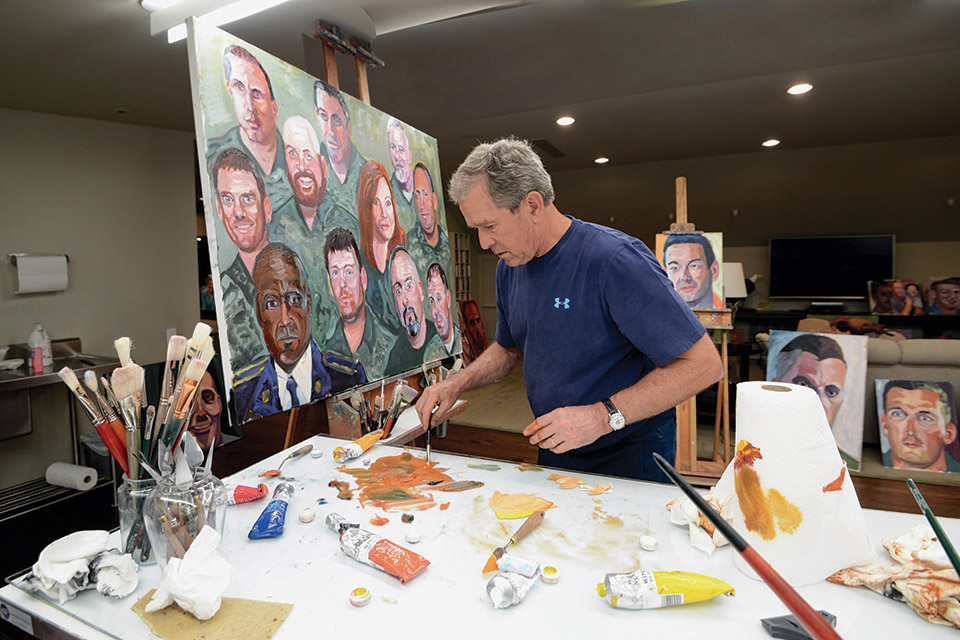 Former president George W. Bush painting for “Portraits of Courage: A Commander in Chief’s Tribute to America’s Warriors” at the National Veterans Memorial and Museum in Columbus (photo courtesy of the National Veterans Memorial and Museum)